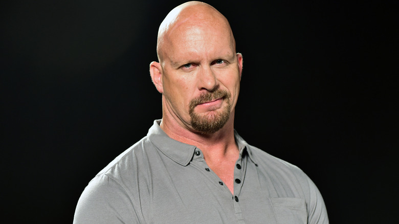 Stone Cold Steve Austin smirking while posing for photo