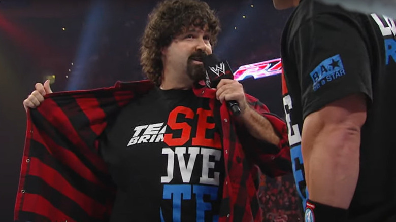 Mick Foley wears half-Cena/half-Rock shirt