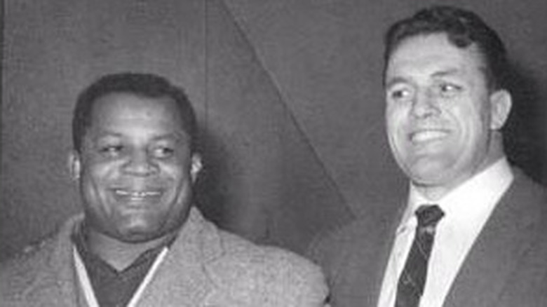 Luther Lindsay and Stu Hart smile for a photo.