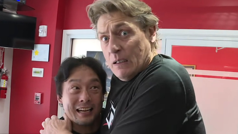 Tajiri and Regal hugging