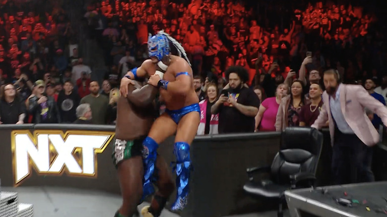 Oba Femi launches Dragon Lee into Wade Barrett's announce chair at NXT Vengeance Day.