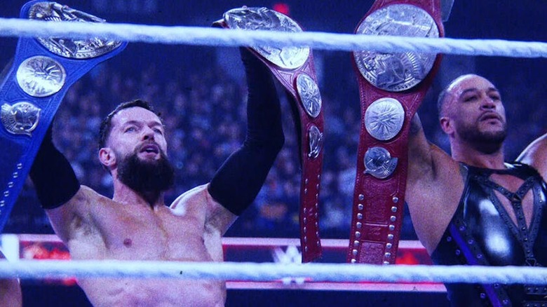 Finn Balor and Damian Priest celebrate retaining their WWE Undisputed Tag Team Championships.