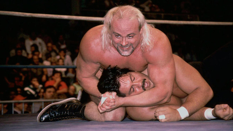 Kevin Sullivan smiles as he cinches in a headlock