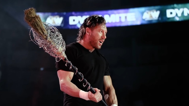 Kenny Omega holding a barbed wire broom