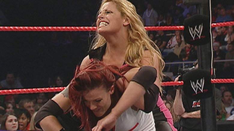 Trish Stratus puts Lita in a full nelson in their Raw main event