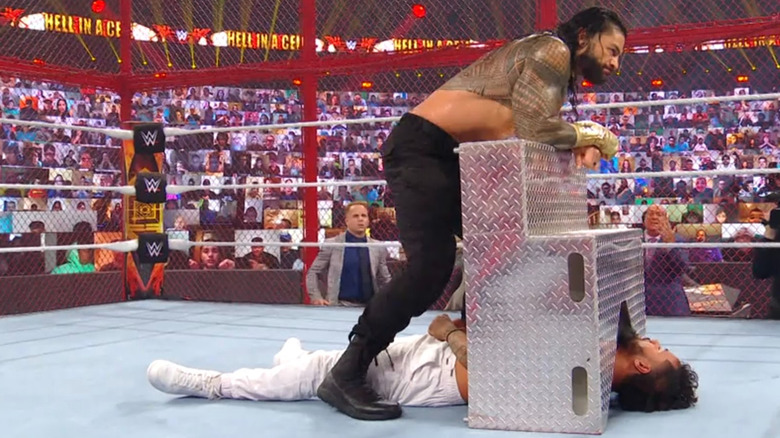Roman Reigns traps Jey Uso under the steel ringsteps