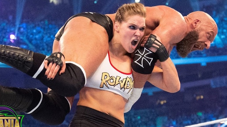 Triple H on Ronda Rousey's Shoulders