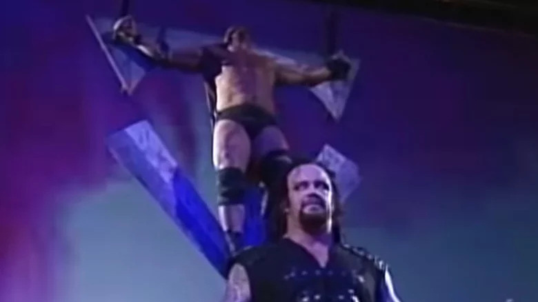 Austin writhing on Undertaker's cross