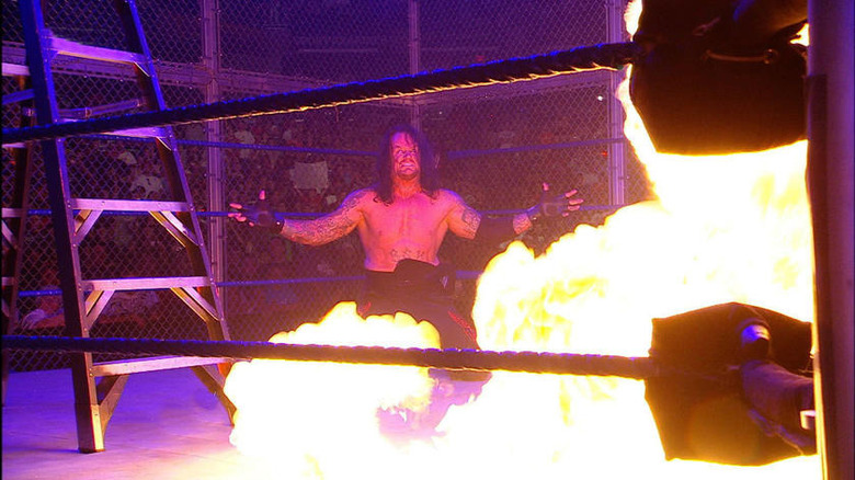 Undertaker posing over the hell portal