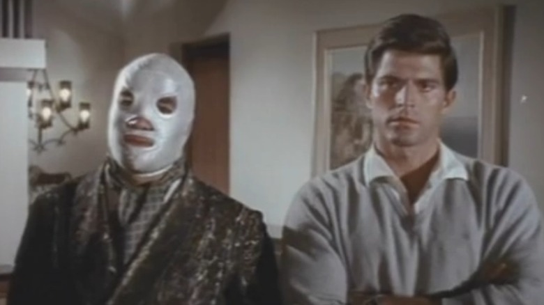 El Santo stands next to man