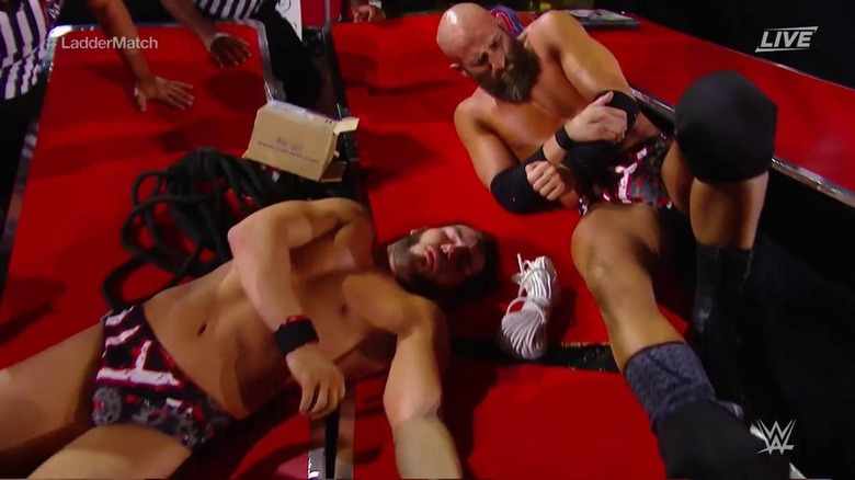 Ciampa wincing after putting Gargano through a table