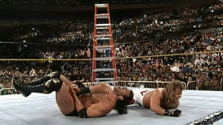 Shawn Michaels and Razor Ramon writhe in pain