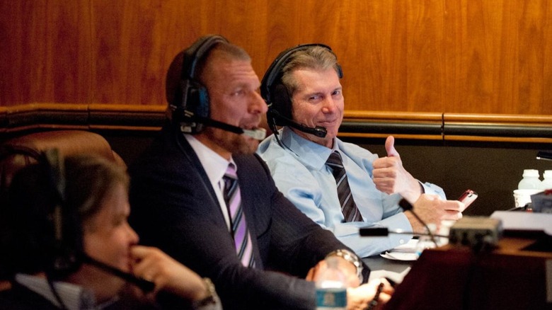 Vince McMahon is seen backstage in WWE's gorilla position alongside Triple H.