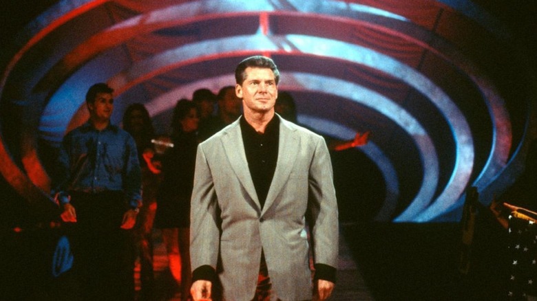 Vince McMahon stands in front of the WWE roster during an episode of television.