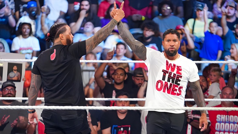 Jimmy and Jey Uso raise their fingers