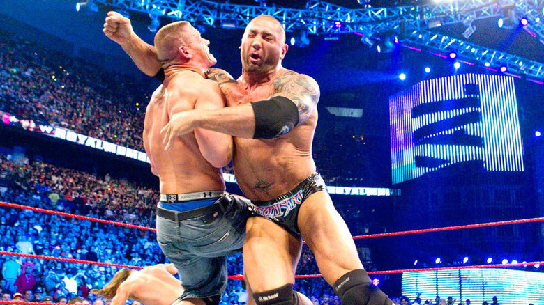 Batista clotheslines Cena