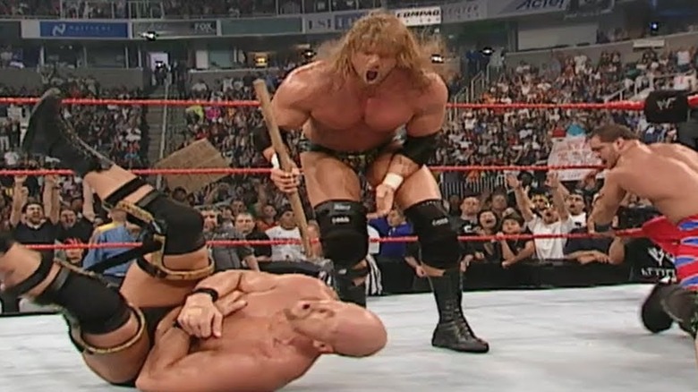 Triple H hits Steve Austin with sledgehammer