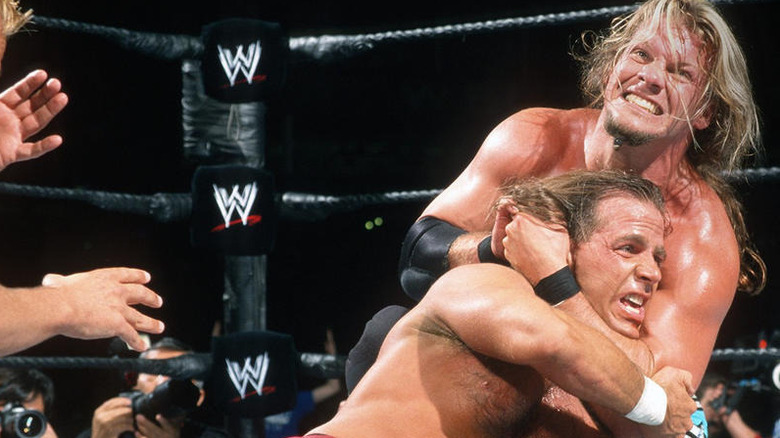 Chris Jericho puts Shawn Michaels in a headlock 