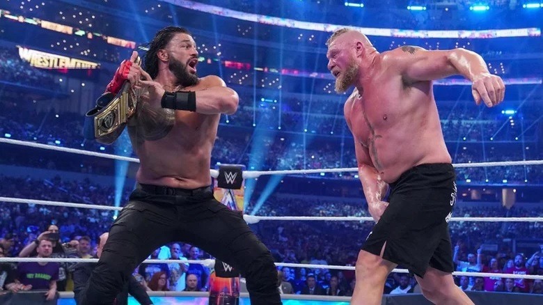 Roman Reigns hitting Brock Lesnar with the title