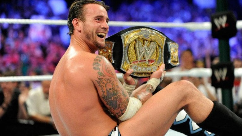CM Punk holding WWE Title