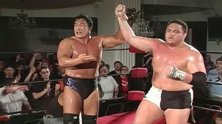 Kenta raises Joe's arm after the match