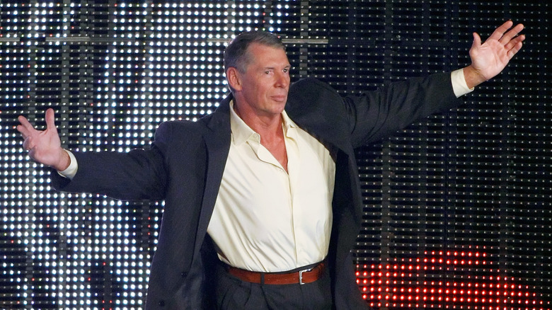 Vince McMahon with his arms outstretched