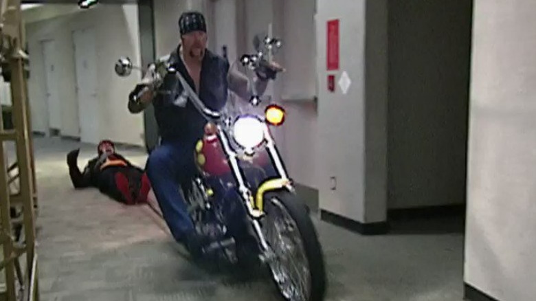 Undertaker dragging Hulk Hogan with his motorcycle