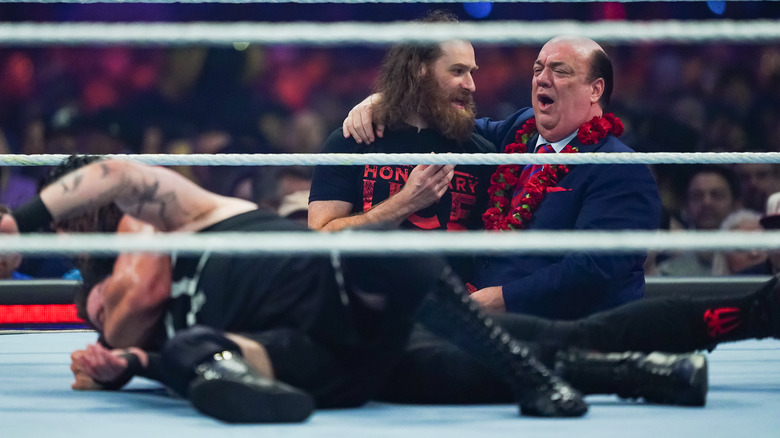 Paul Heyman chuckling with Sami Zayn