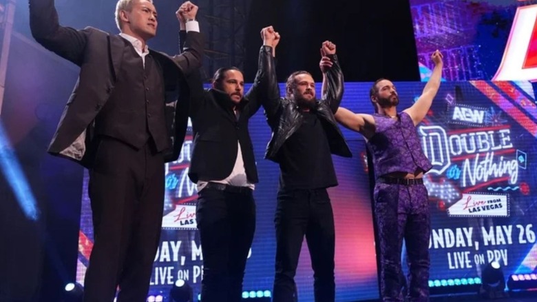 Kazuchika Okada, Matthew and Nicholas Jackson, and Jack Perry stand with their hands raised on the stage during "AEW Dynamite."