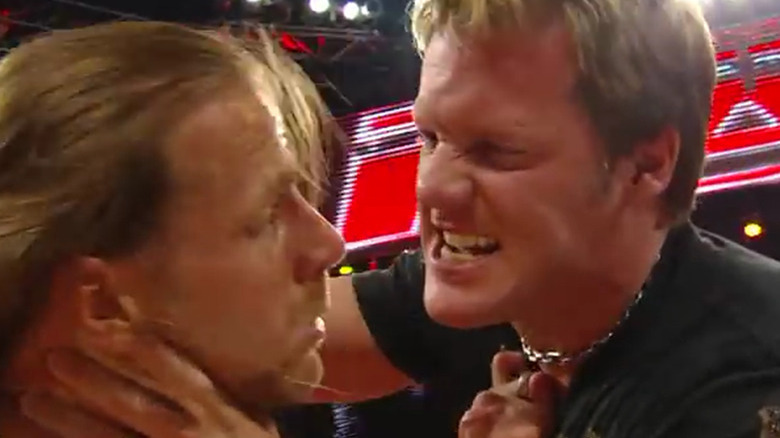 Jericho holding Michaels' face close to his