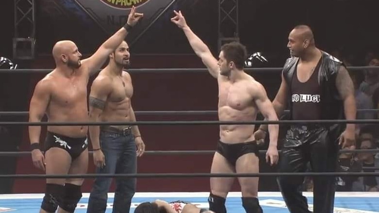The Bullet Club throwing up their gesture