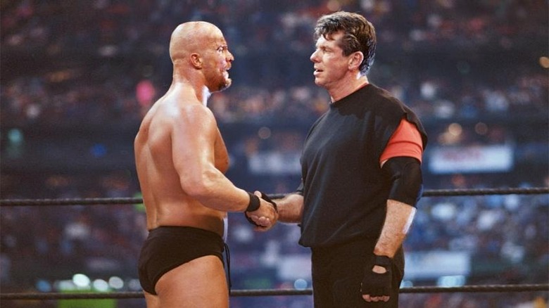 Austin and McMahon shake hands in the ring