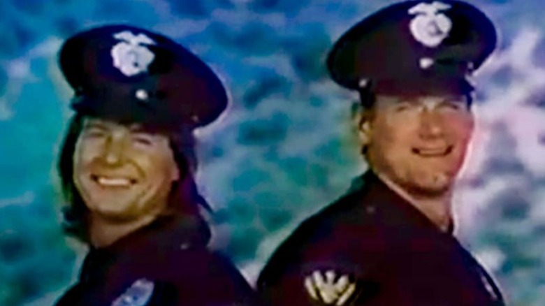 Roddy Piper and Jesse Ventura as cops