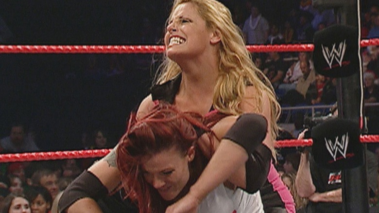 Trish Stratus and Lita wrestling in 2004 WWE Raw main event