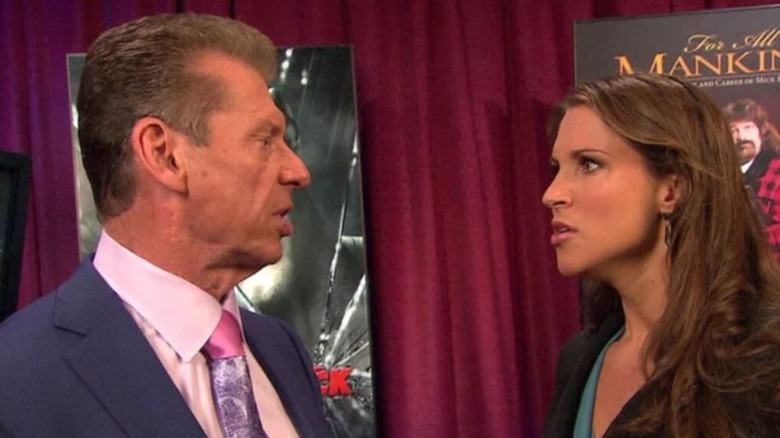 Stephanie McMahon looks angrily at her father, Vince McMahon backstage