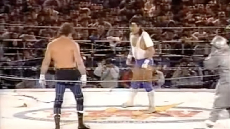 Onita and Funk squaring off in the ring