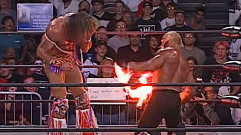 Hulk Hogan lights fire in front of Warrior