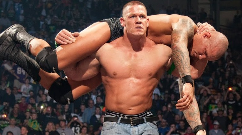 John Cena with Randy Orton on his shoulders