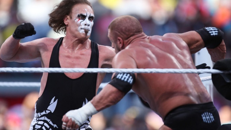 Sting punching Triple H