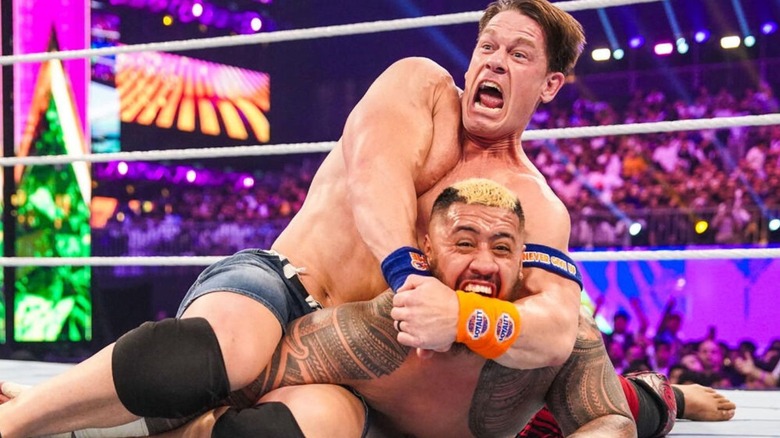 John Cena has Solo Sikoa down on the mat, in his STF submission move, during their match at Crown Jewel in 2023.