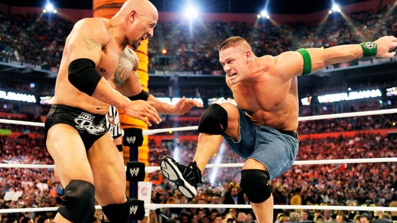 John Cena kicks the The Rock in the middle of the ring during their "One in a Lifetime" match at WrestleMania 28.