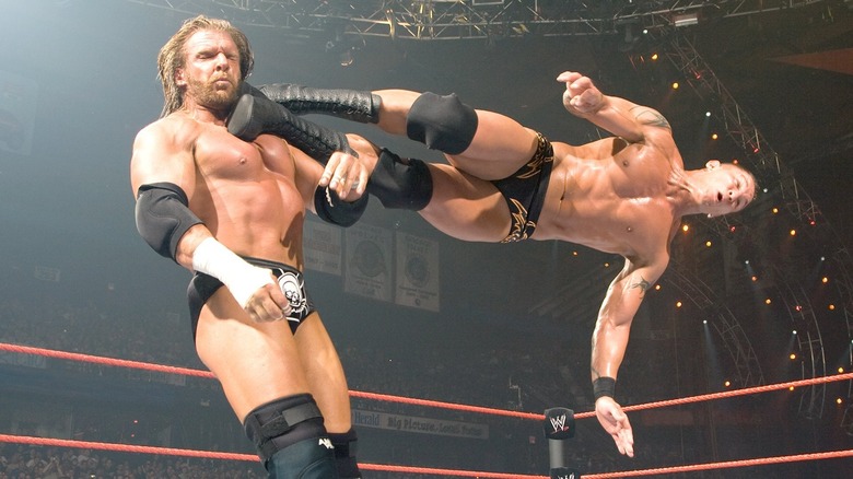 Randy Orton dropkicks Triple H