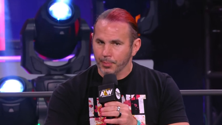 Matt Hardy holding a microphone inside an AEW ring