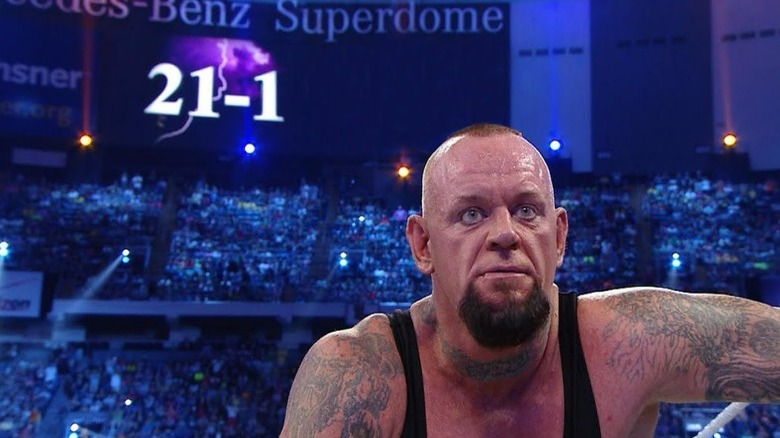 Undertaker with a 21-1 billboard behind him