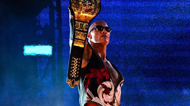 Dwayne "The Rock" Johnson holds up the "People's Championship" on the stage as he makes his entrance in the main event of night one of WrestleMania 40.