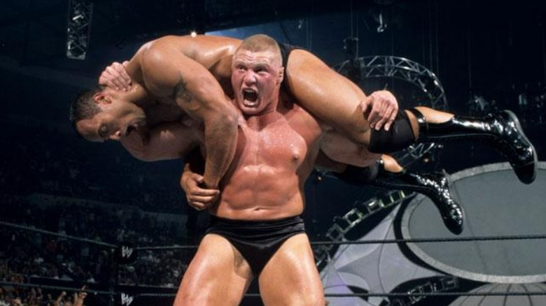 Brock Lesnar with the Rock on his shoulders