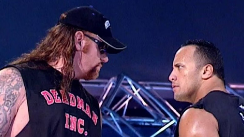 The Undertaker and the Rock having a staredown