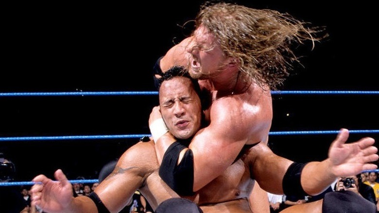 Triple H putting The Rock in a headlock