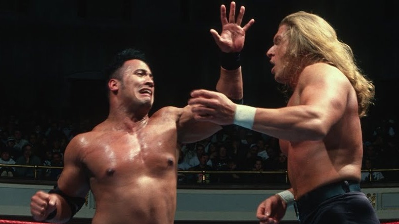 Rocky Maivia punching Triple H