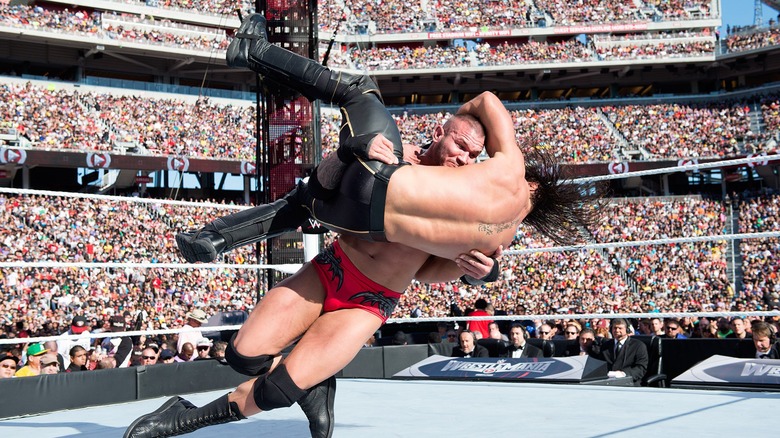 Randy Orton powerslams Seth Rollins